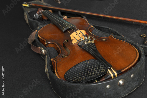 Old violin on a black background