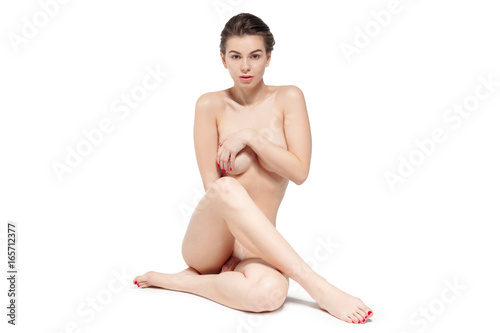Young nude woman sitting on the floor