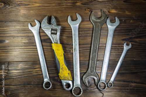 Old wrench tools on wooden background