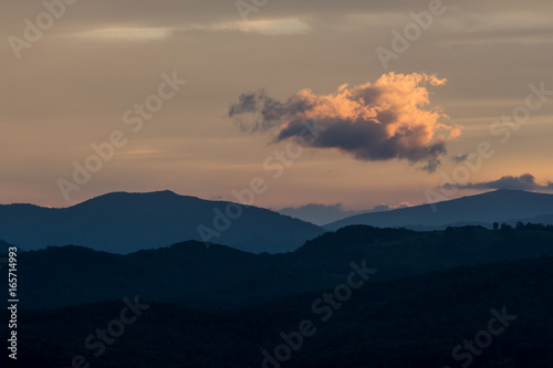 Bright Cloud Hangs Above Mountain Ridge