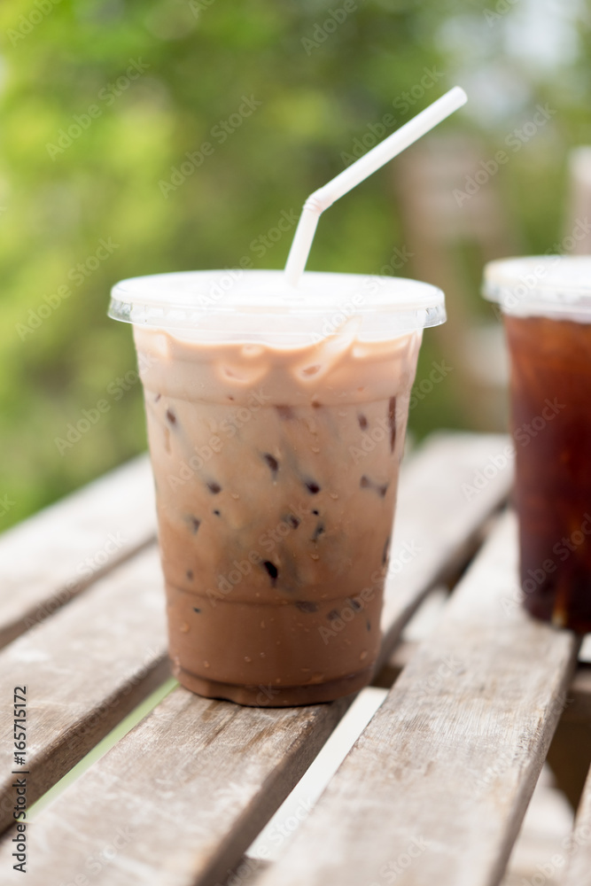 Iced coco or chocolate with straw in plastic cup