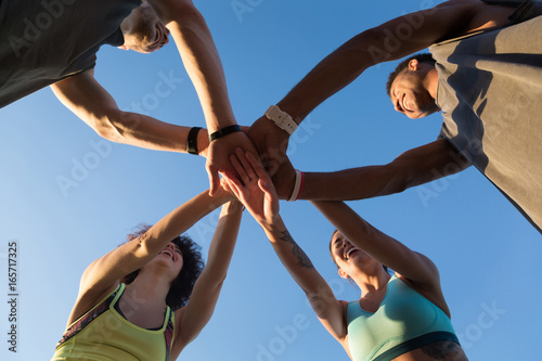View from below of a group of sporty people in a huddle