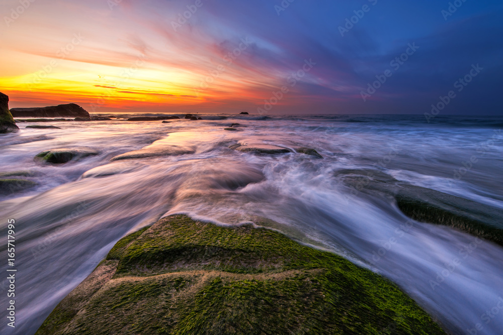 vibrant sunset with green moss at Kudat Sabah Malaysia. Image contain soft focus due to long exposure. vibrant sunset with green moss at Kudat Sabah Malaysia. Image contain soft focus due to long exposure.