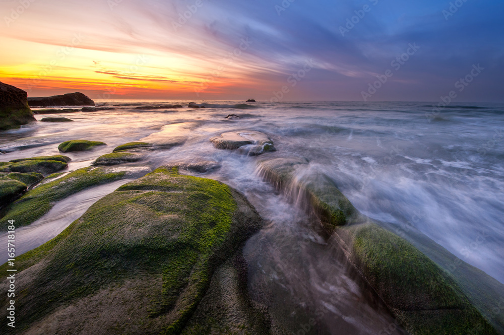 Long expose sunset with waves trails  at Kudat Sabah Malaysia. Image contain soft focus due to long exposure.