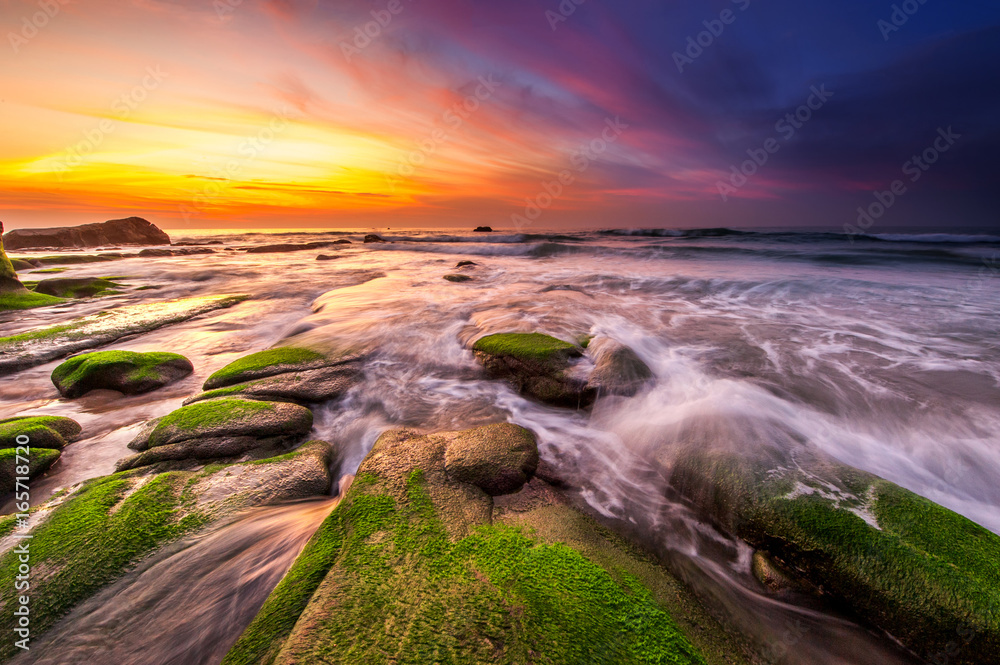 Colorful sunset with green moss at Kudat Sabah Malaysia. Image contain soft focus due to long exposure. Colorful sunset with green moss at Kudat Sabah Malaysia. Image contain soft focus due to long exposure.