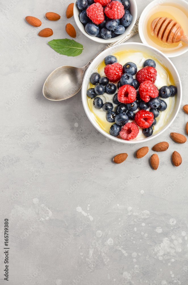 Natural yogurt with fresh berries and honey, healthy breakfast concept, top view, copy space Natural yogurt with fresh berries and honey, healthy breakfast concept, top view, copy space