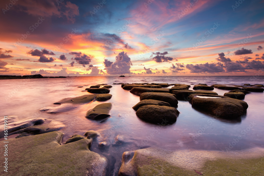 view of rocks covered by green moss at Tip of Borneo, Malaysia. Image contain soft focus due to long exposure.