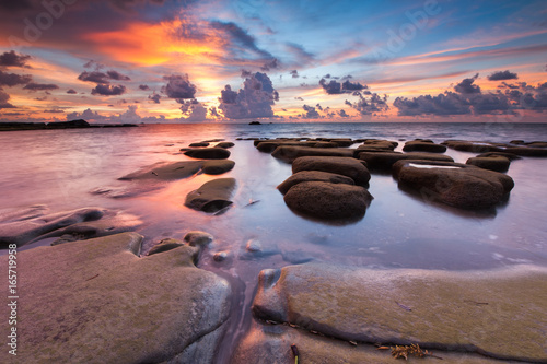 view of rocks covered by green moss at Tip of Borneo, Malaysia. Image contain soft focus due to long exposure.