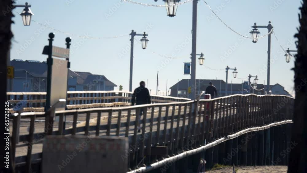 People walking over bridge in santa barbara california People walking over bridge in santa barbara california