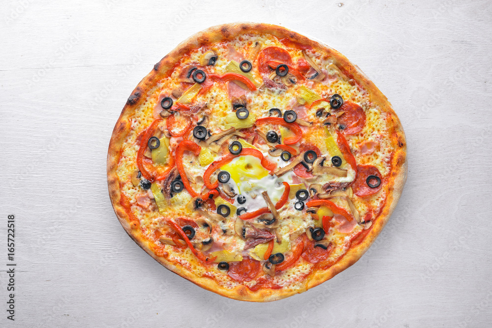 Pizza with vegetables. On a wooden background. Top view. Free space for your text.