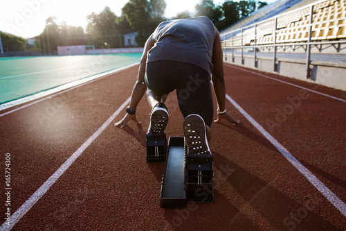 Back view of a young male athlete at starting block