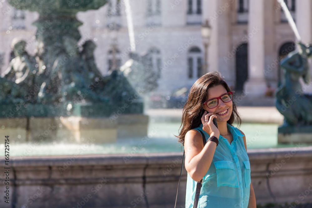 young girl in blue blouse and red glasses on the streets young girl in blue blouse and red glasses on the streets