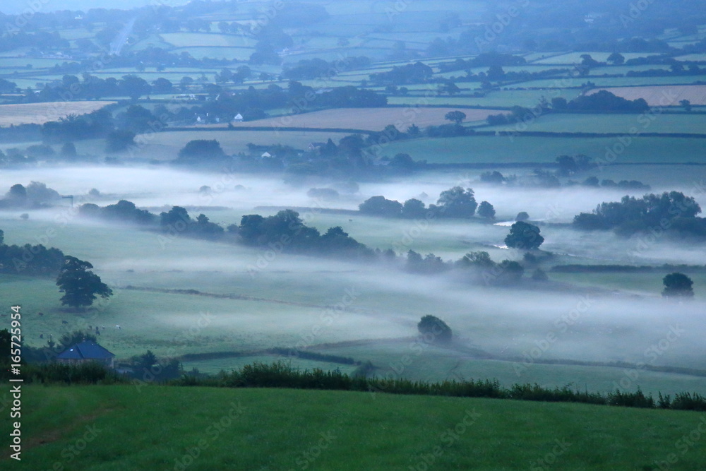 Sunrise on a misty morning over Axe Valley in East Devon, England