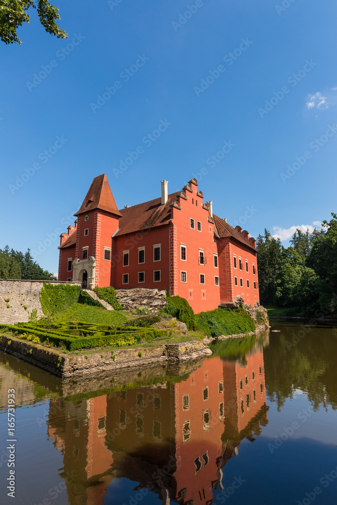 Nice romantic castle with red color in the middle of lake