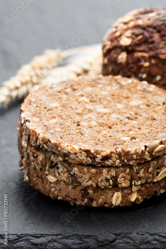 Sliced  rye bread on black stone background