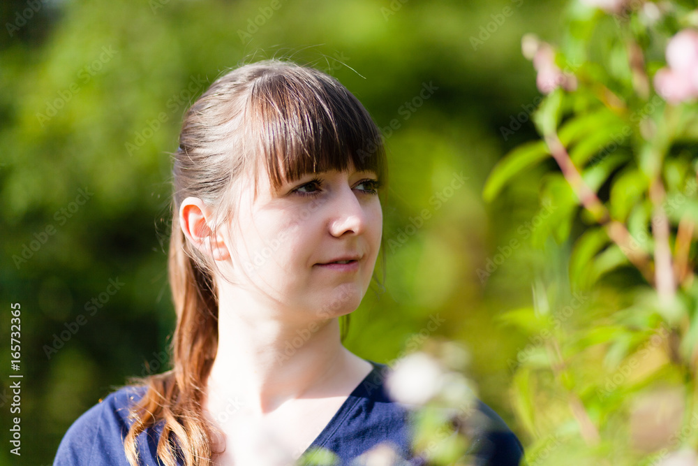 Portrait of an Attractive Young Woman Looking right at camera smiling and laughing close up