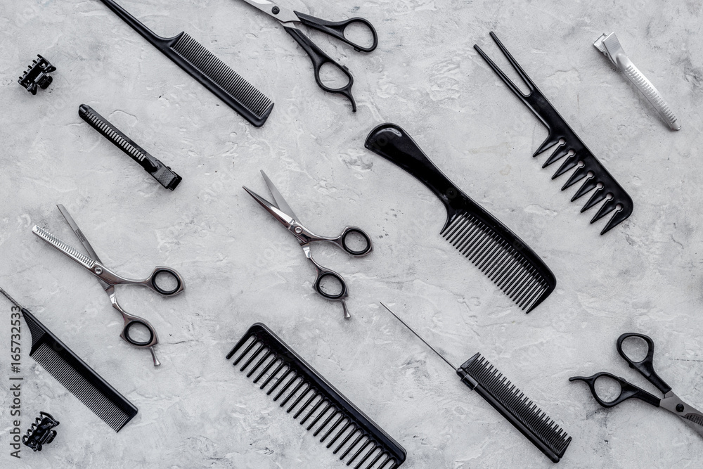 Pattern of combs and hairdresser tools on grey table background top view Pattern of combs and hairdresser tools on grey table background top view