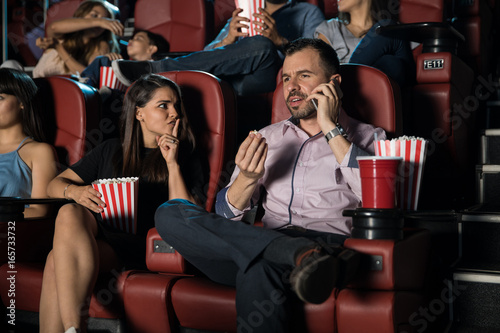 Man talking on the phone at the movies photo