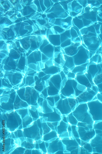 Texture of clear blue water in the swimming pool