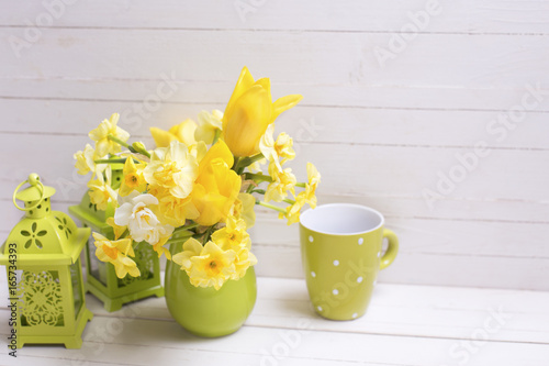 Yellow spring daffodils or narcissus flowers  and decorative green lanterns