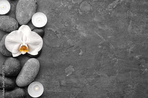Fototapeta Naklejka Na Ścianę i Meble -  Composition with beautiful white orchid and stones on grey background