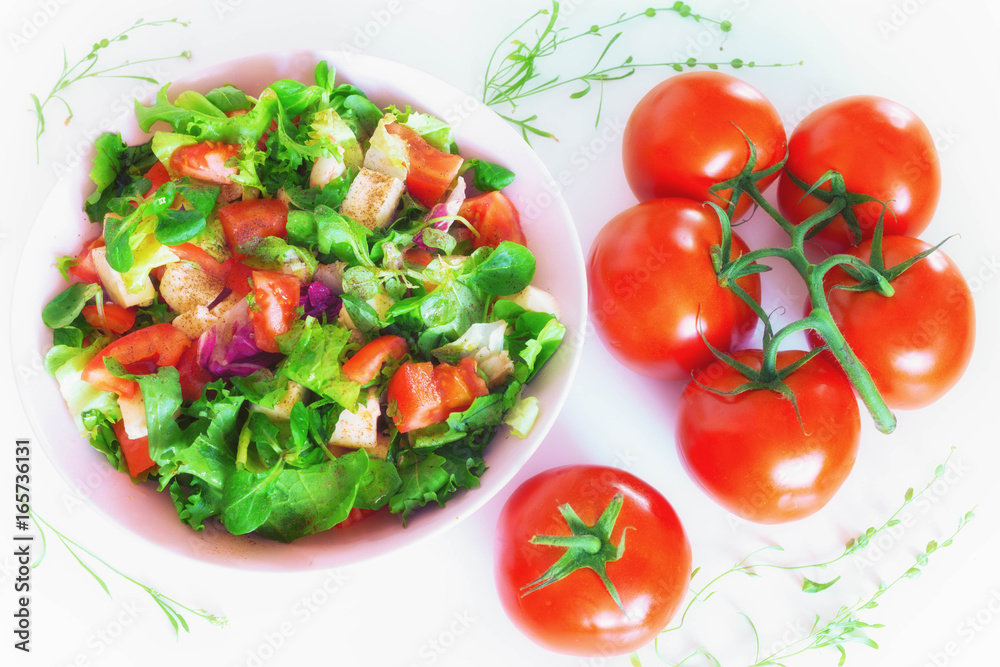Vegetable salad with toppings such as mozzarella cheese, tomato, olive oil and spices