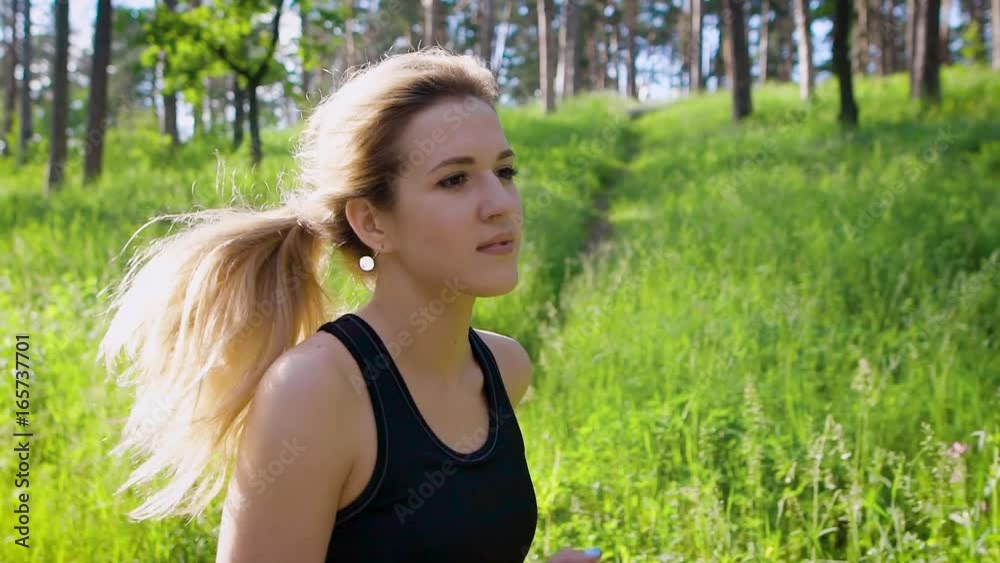 Beautiful caucasian woman running in countryside. Sport and healthy lifestyle Beautiful caucasian woman running in countryside. Sport and healthy lifestyle