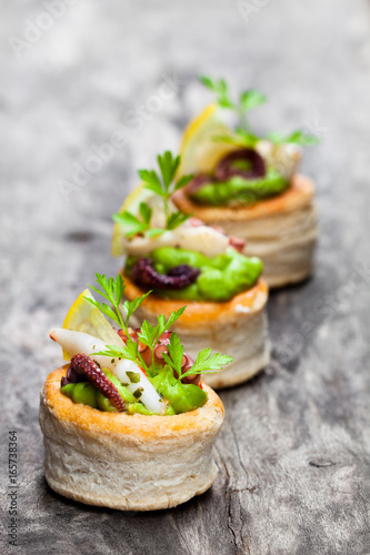 Vol-au-vents  puff pastry cases filled with salted squid and octopus photo