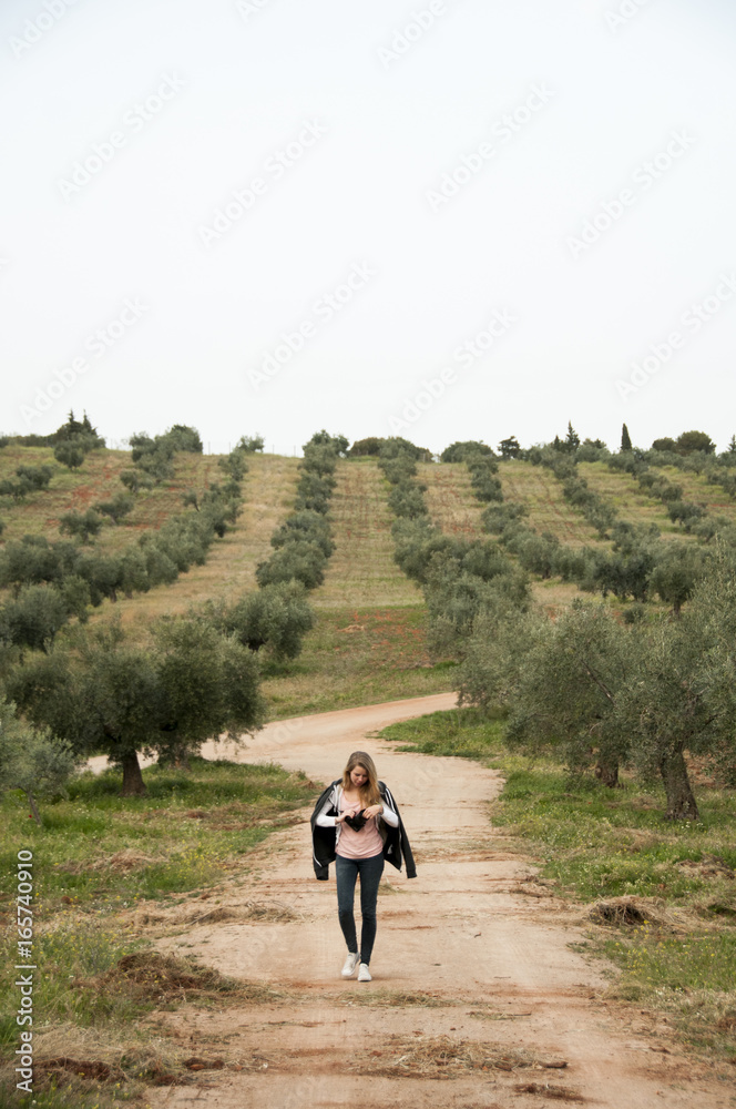 Young woman walking in vineyard, Granada, Spain
