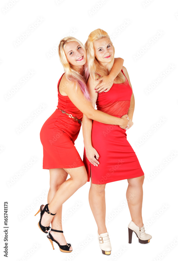 Hugging pretty girls in red dresses isolated on white background Hugging pretty girls in red dresses isolated on white background