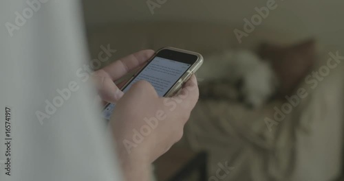 A man uses his smart phone at home.
