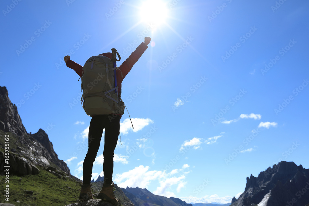 cheering woman with backpack hiking in mountains travel lifestyle success concep cheering woman with backpack hiking in mountains travel lifestyle success concep