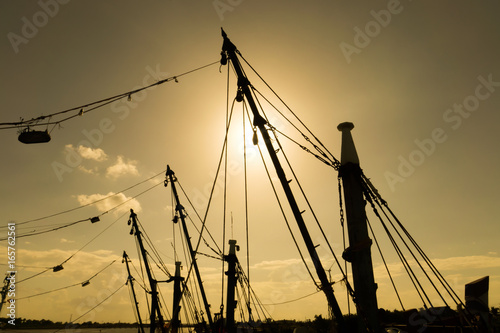 The silhouette masts of fishing boats
