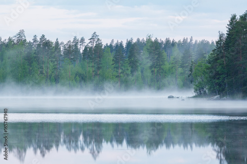 Foggy calm lake and forest at summer night © Juhku