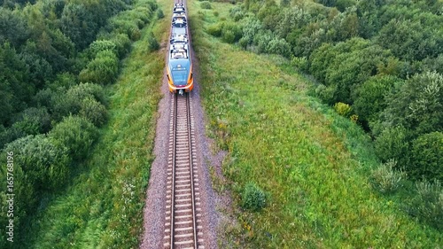 An aerial of A steam train as It passes through the Estonian countryside at hig photo