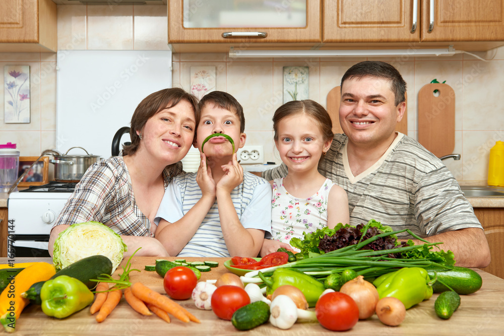 family portrait in kitchen interior at home, fresh fruits and vegetables, healthy food concept, woman, man and children cooking and having fun family portrait in kitchen interior at home, fresh fruits and vegetables, healthy food concept, woman, man and children cooking and having fun