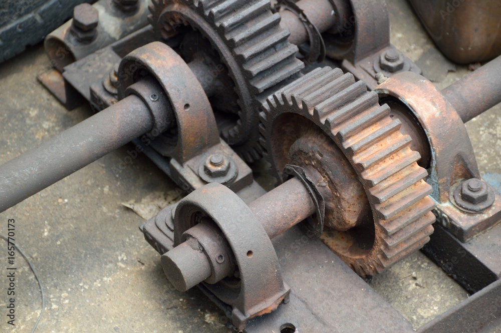 close up rusty iron gear on the ground