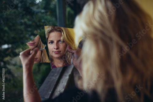 Woman portrait with broken mirror. Split personality, or schizophrenia concept.