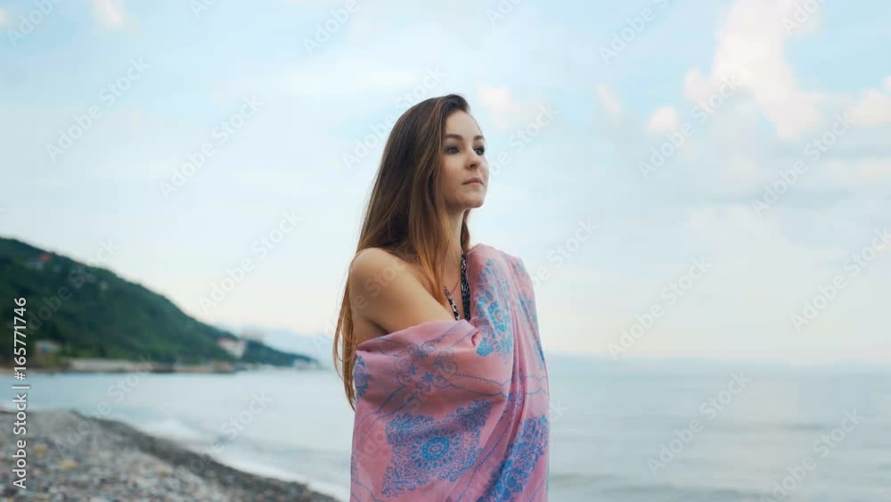 Beautiful thinking woman walking along the coastline. Beautiful thinking woman walking along the coastline.