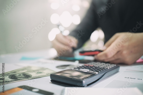 calculate on desk with Business man doing finance.