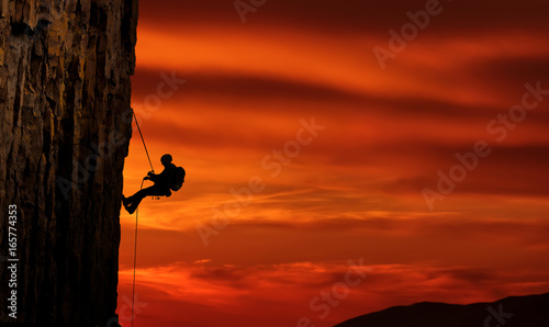 Climber silhouette over beautiful sunset