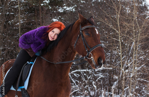 Woman with red hair and big horse outdoor in winter © keleny