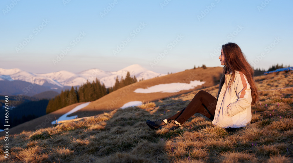 Shot of a woman admiring stunning view sitting on top of a mountain copyspace peace nature harmony lifestyle active sportive healthy relaxing resting meditative