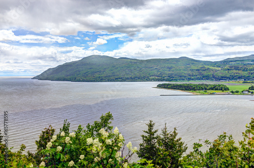 Baie-Saint-Paul in Quebec, Canada cityscape or skyline with mountains on coast and Saint Lawrence river photo