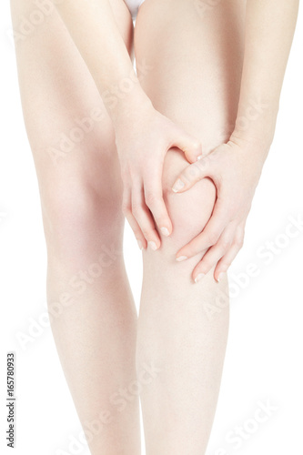 Woman fatigued legs with hands touching knee isolated on white, clipping path