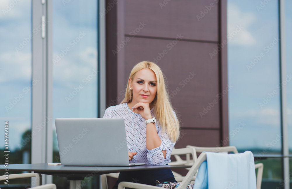 Adult businesswoman working on laptop in cafe Adult businesswoman working on laptop in cafe