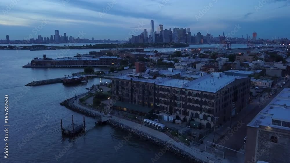 dusk flying over Red Hook Brooklyn Waterfront towards view of Manhattan dusk flying over Red Hook Brooklyn Waterfront towards view of Manhattan