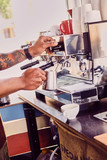 Close up image of a man preparing coffee late.