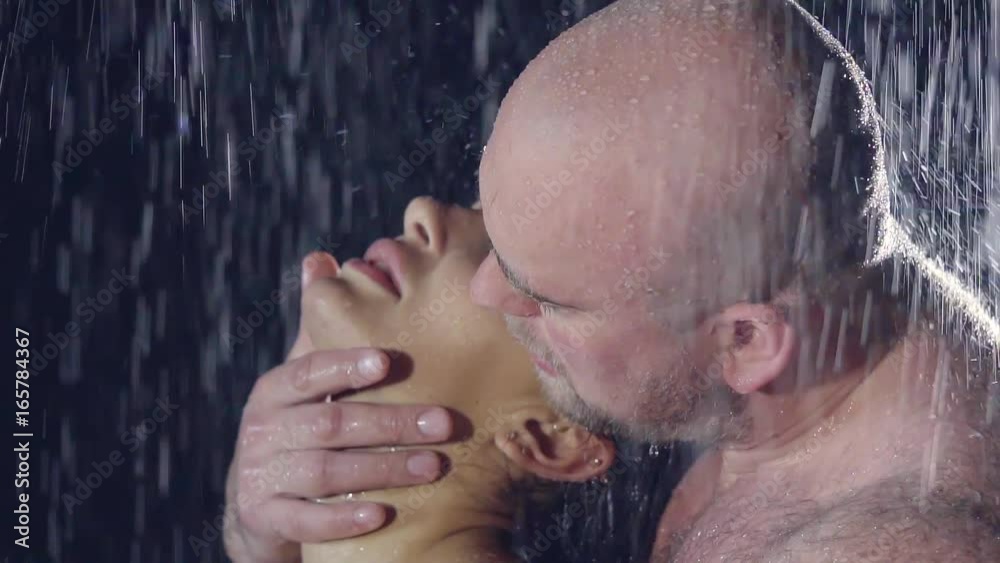young woman and young man in the shower. naked wet bodies. bald brutal man with hairy body
