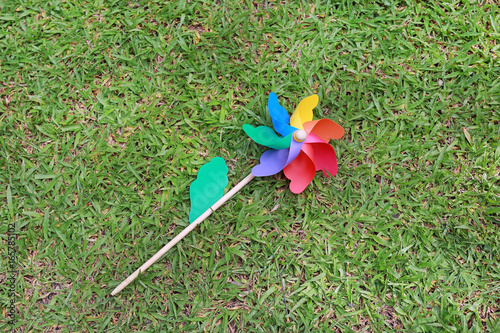 Colorful pinwheel over green grass.